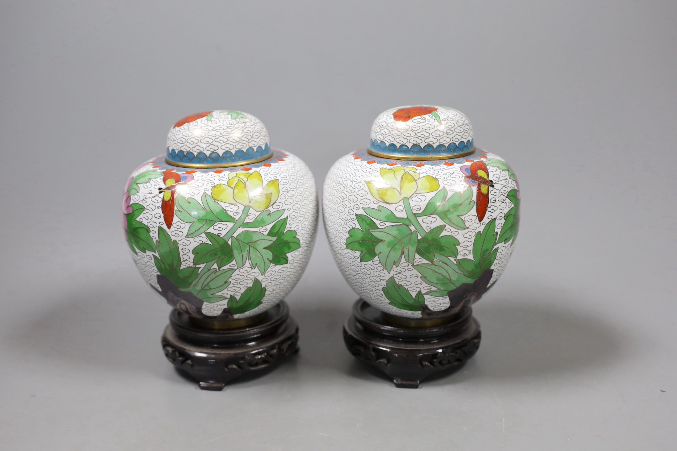 A pair of Chinese cloisonné enamel jars and covers on stands, total height 15.5 cm